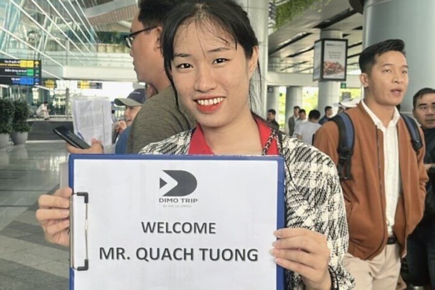 A person holding a welcome sign for Mr. Quach Tuong at an airport. 4