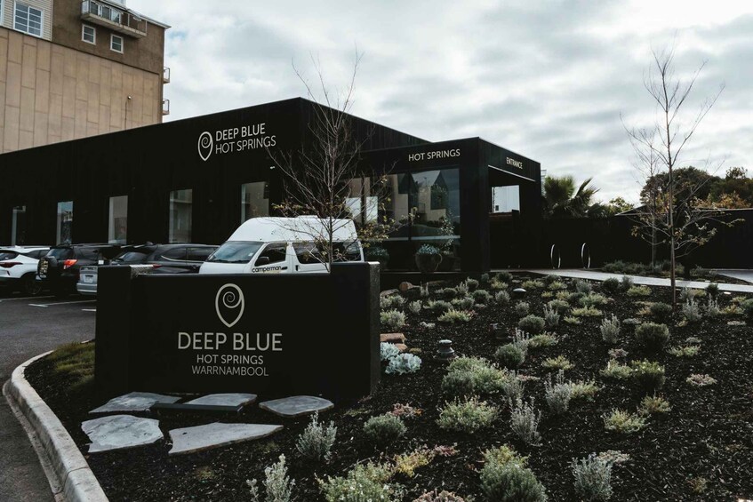 A building with a sign reading 'Deep Blue Hot Springs Warrnambool.' 2