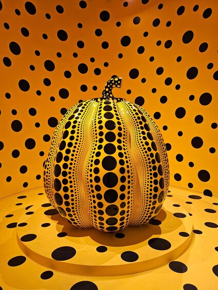 A pumpkin with a polka dot pattern against a similarly patterned background. 1