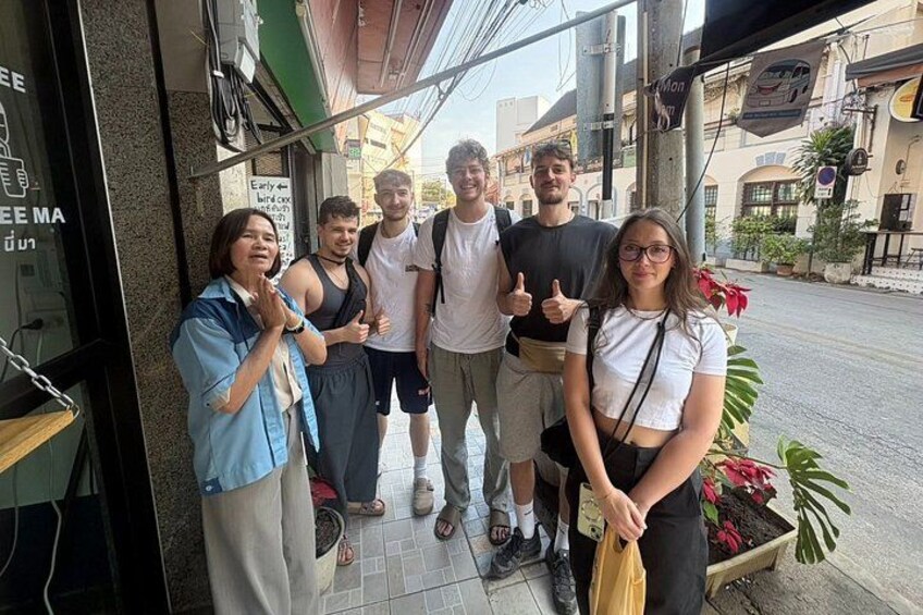 A group of people standing outside a cafe with a sign that reads 'Early Bird Special.' 5