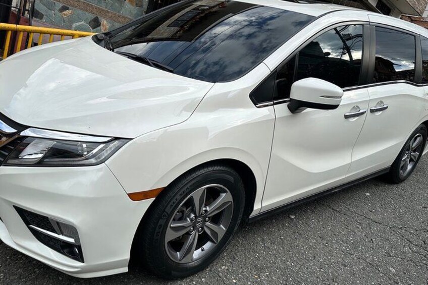 A white car parked on a paved surface. 1