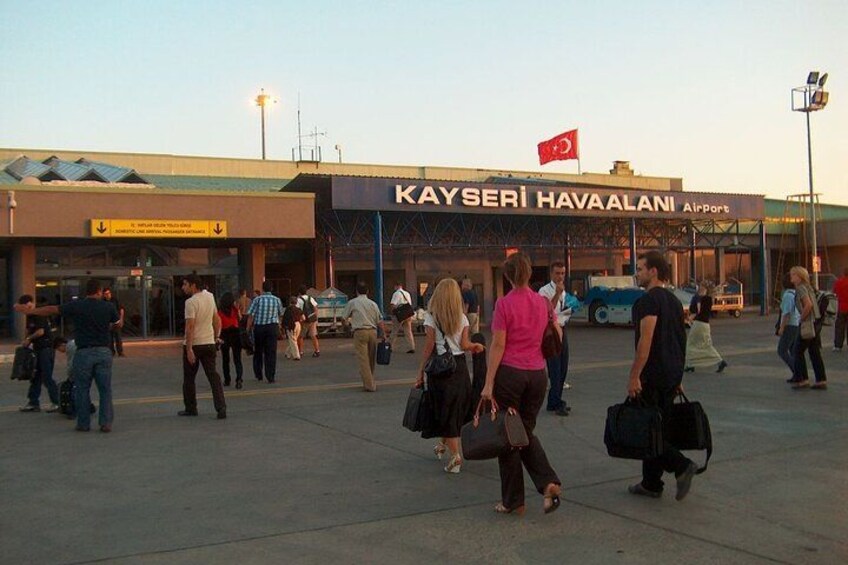 A busy airport terminal with people walking and luggage. 2