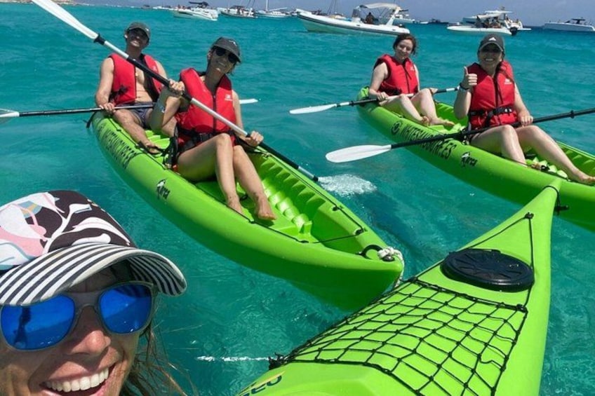 People kayaking in a clear blue sea. 1