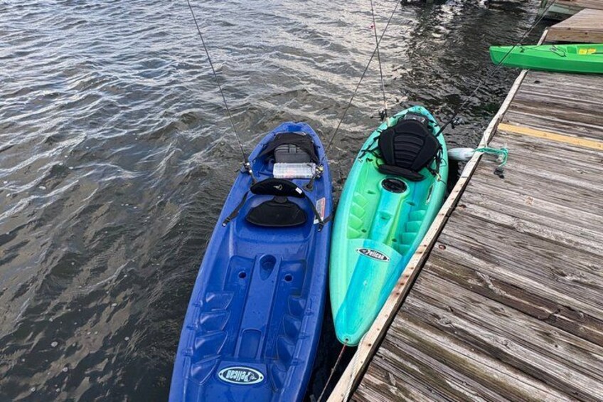 Two kayaks, one blue and one green, docked at a wooden pier. 3