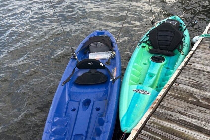 Two kayaks docked at a wooden pier. 4