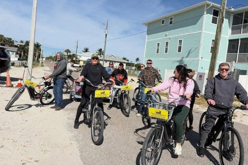 A group of people on bicycles on a street. 2