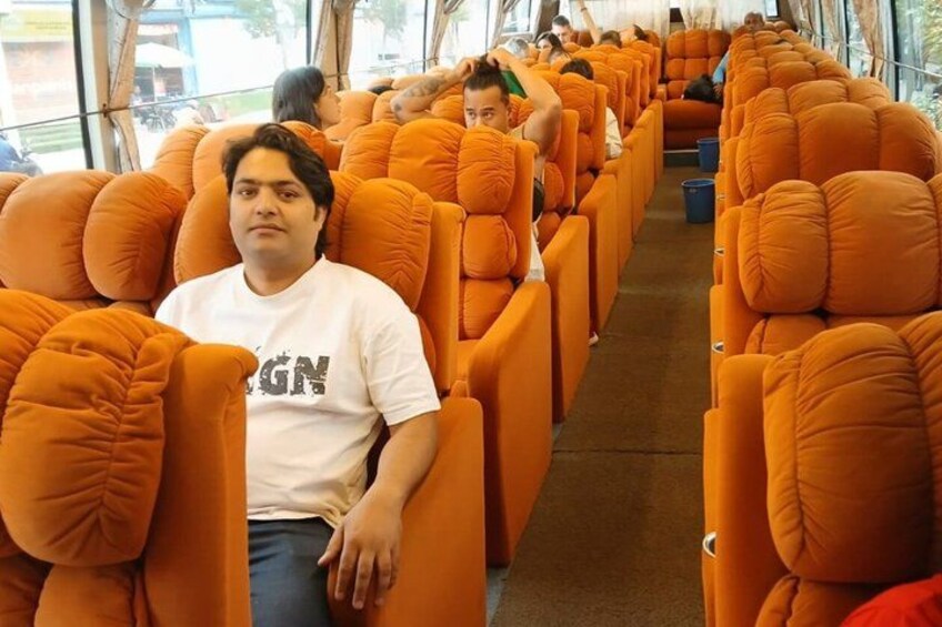 A row of orange seats in a bus or train interior. 1