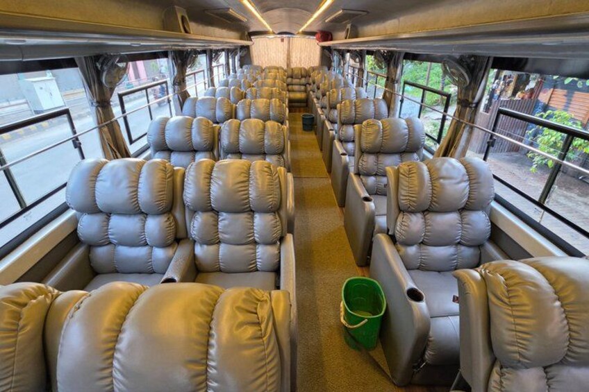 A train interior with rows of leather seats and windows. 5