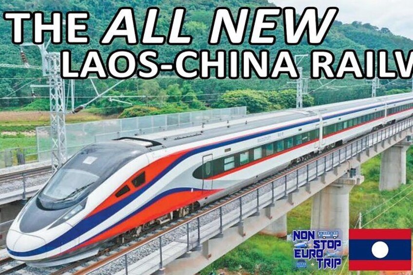 A high-speed train on a bridge with a mountainous landscape in the background. 1