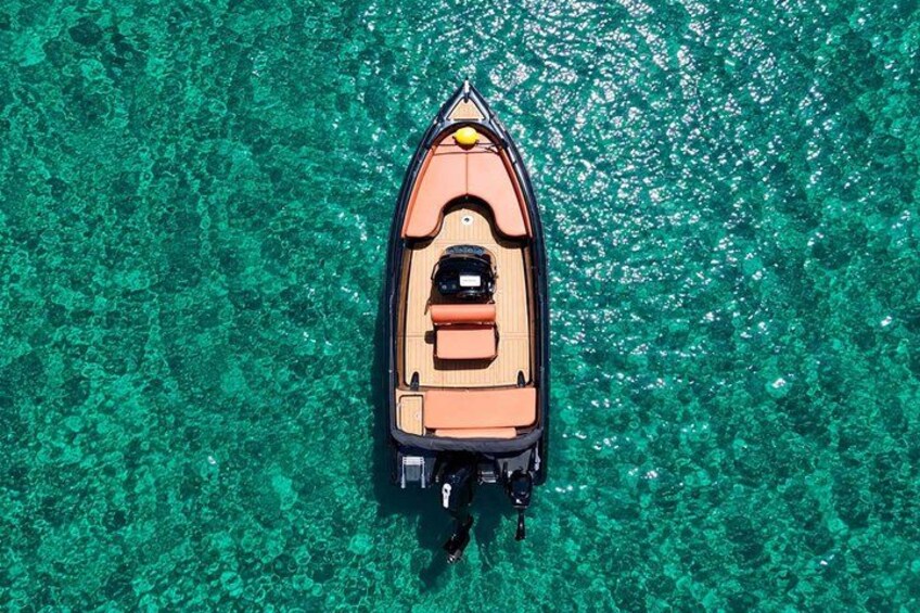 A small boat on clear turquoise water. 5