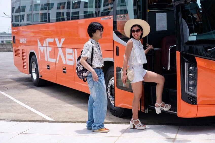 A person standing next to a bus with the word 'MEXICO' on it. 5