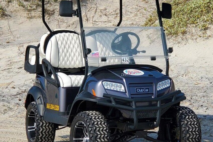 A golf cart with a quilted seat, a steering wheel, and a ClubCar logo. 1