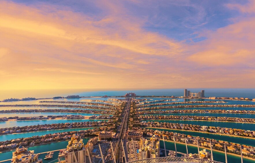 A coastal cityscape with a prominent bridge and a marina with numerous boats. 1
