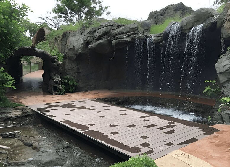 Une terrasse en bois menant à une cascade rocheuse. 4