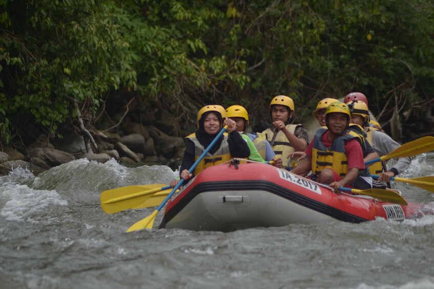 A group of people in a raft navigating through a river. 5