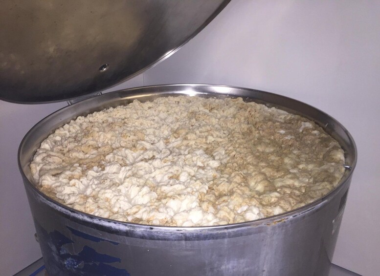A large metal pot filled with cooked rice. 2