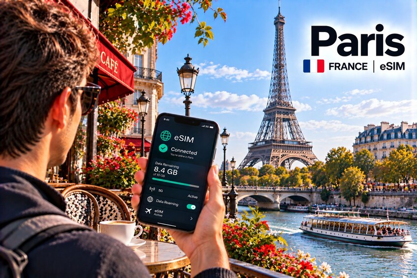 A person using an eSIM device in Paris with the Eiffel Tower in the background. 1
