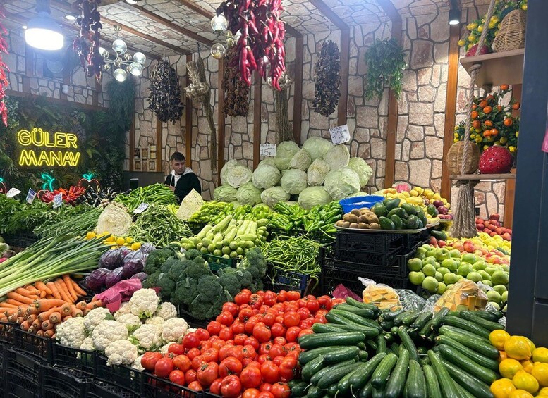 A market with fresh produce, including tomatoes, cucumbers, and carrots. 5