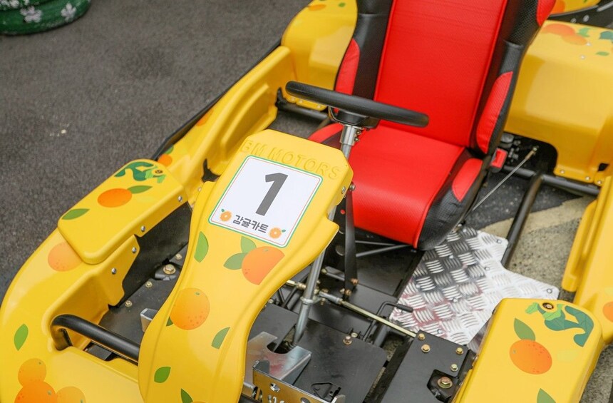 A racing car with a number 1 sign, yellow and red seats, and a steering wheel. 3