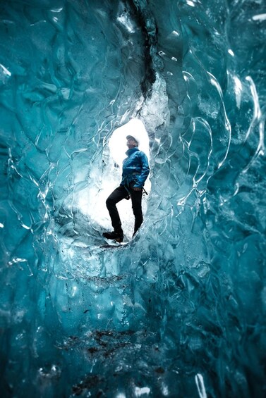 A person ice skating inside a transparent ice cave. 5