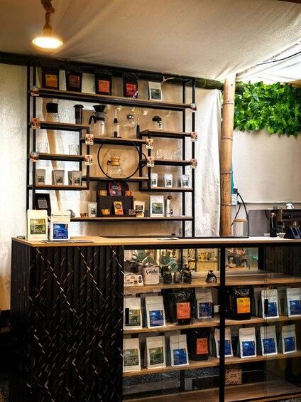 Een koffiebar interieur met planken vol koffiebonen en een glazen vitrine. 1