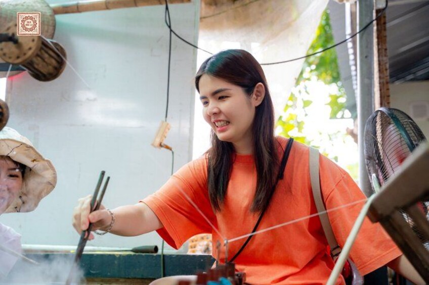 A person cooking outdoors with a wok and a fan in the background. 4