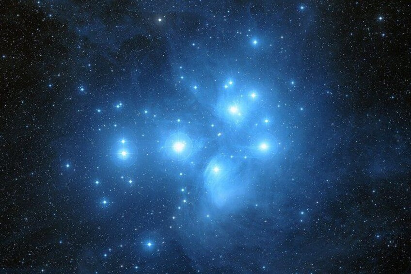 A starry night sky with a cluster of bright stars and a nebula. 5