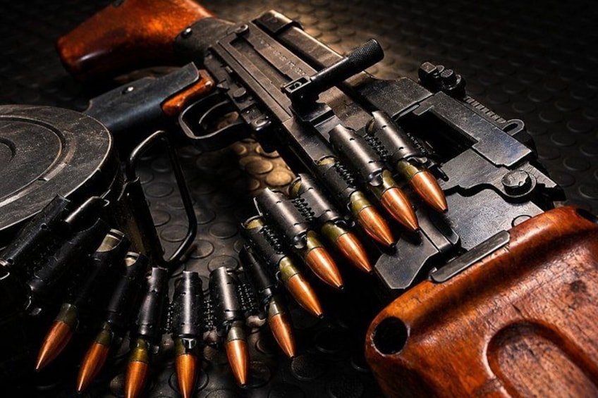 A firearm with a wooden stock and a magazine loaded with bullets. 1