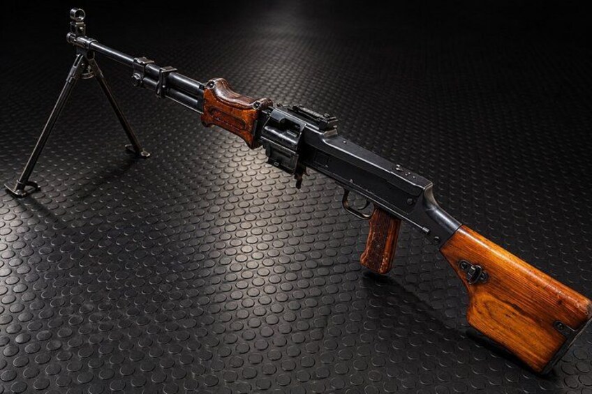 A rifle with wooden grips and a tripod stand. 2