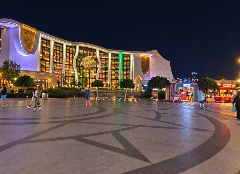 A modern building with a curved facade and a large spherical structure on the roof. 5