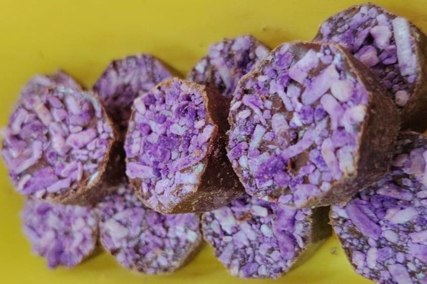 A collection of purple-colored food items with a textured surface, arranged on a yellow background. 5