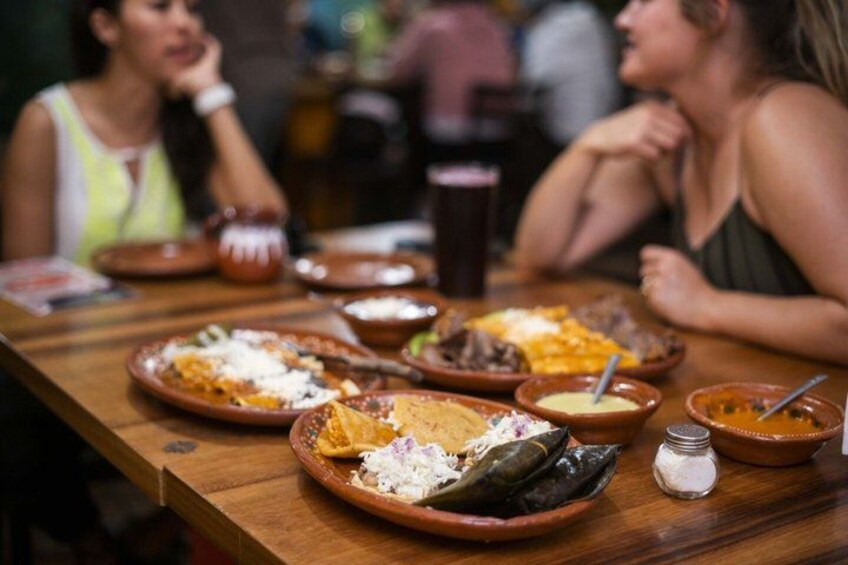 A wooden table with various dishes, including plates of food and bowls. 1