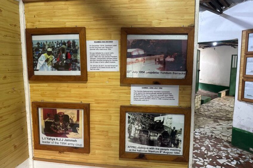 A wooden display with framed photographs and text about historical events. 5