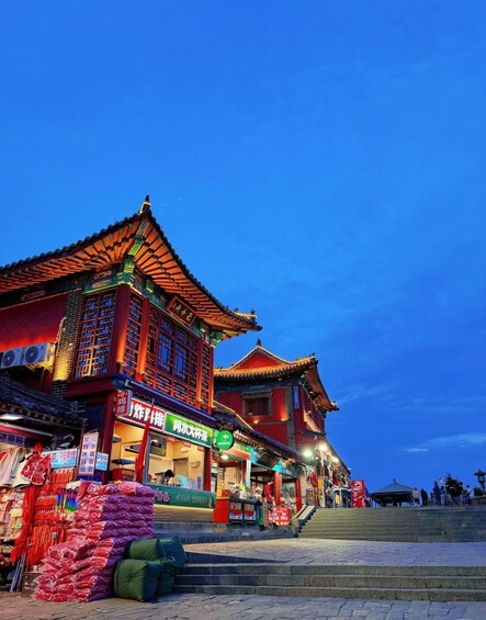 A traditional building with a tiled roof and colorful signage. 5