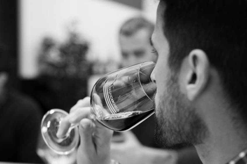 A person holding a wine glass. 2