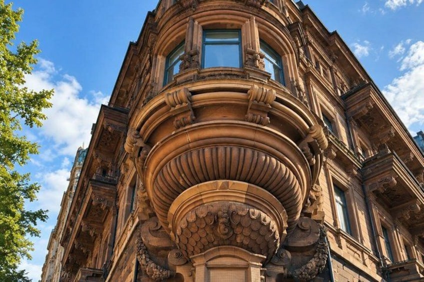 A historic building with ornate architectural details, including a prominent cornice and decorative stonework. 3