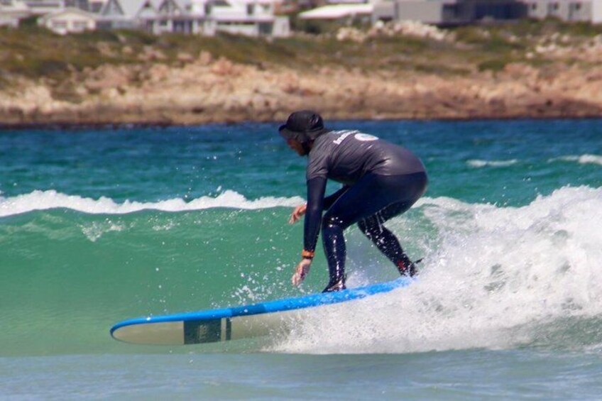 A person surfing on a wave in the ocean. 5