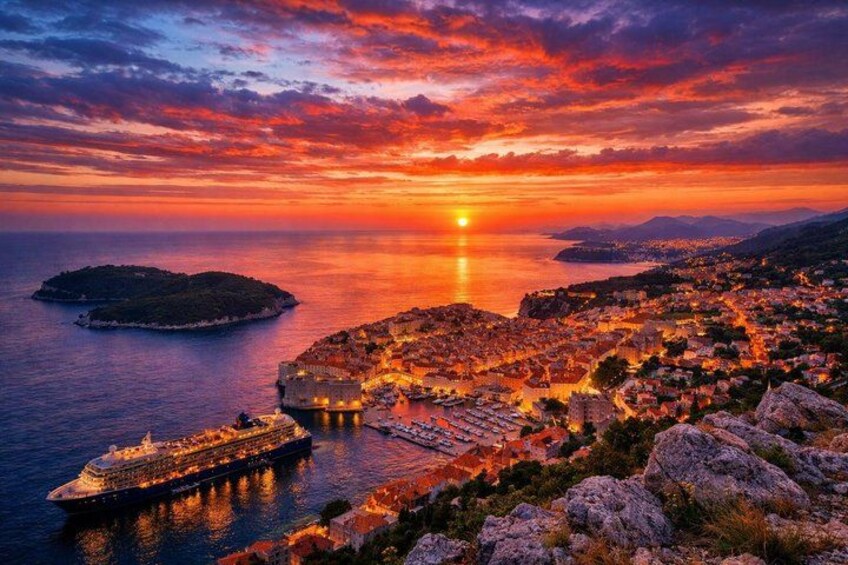 A sunset over a coastal city with a cruise ship docked near the waterfront. 2