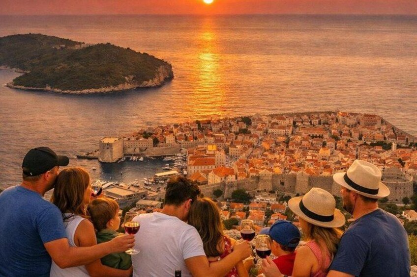 A sunset over a coastal city with a historic fort and a small island in the distance. 4
