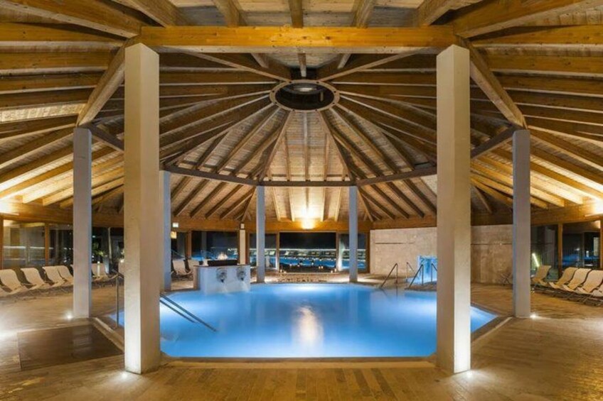 An indoor swimming pool with wooden beams and columns. 2
