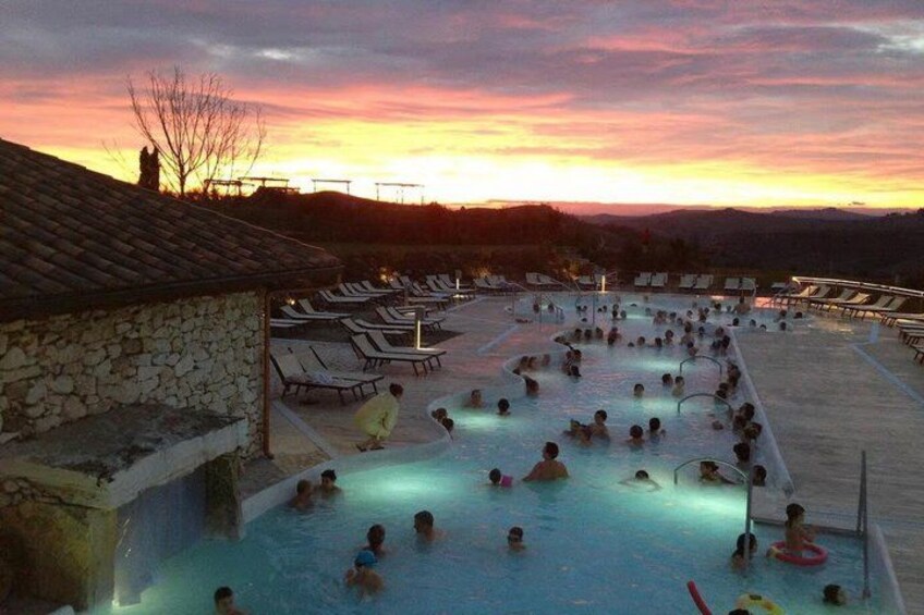A swimming pool with people at sunset. 1