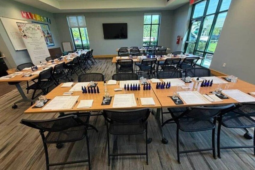 A conference room with multiple tables, chairs, and documents. 4