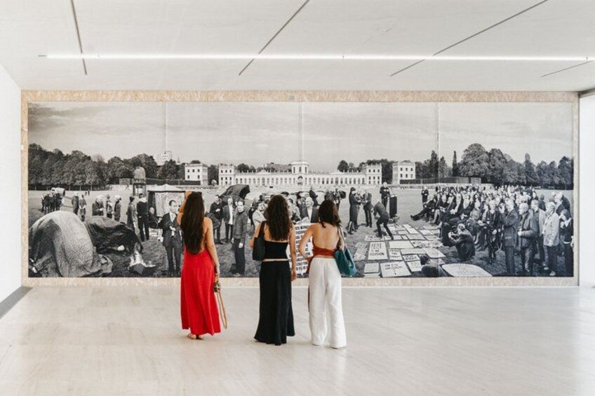 A mural of a historical event with people and buildings. 4