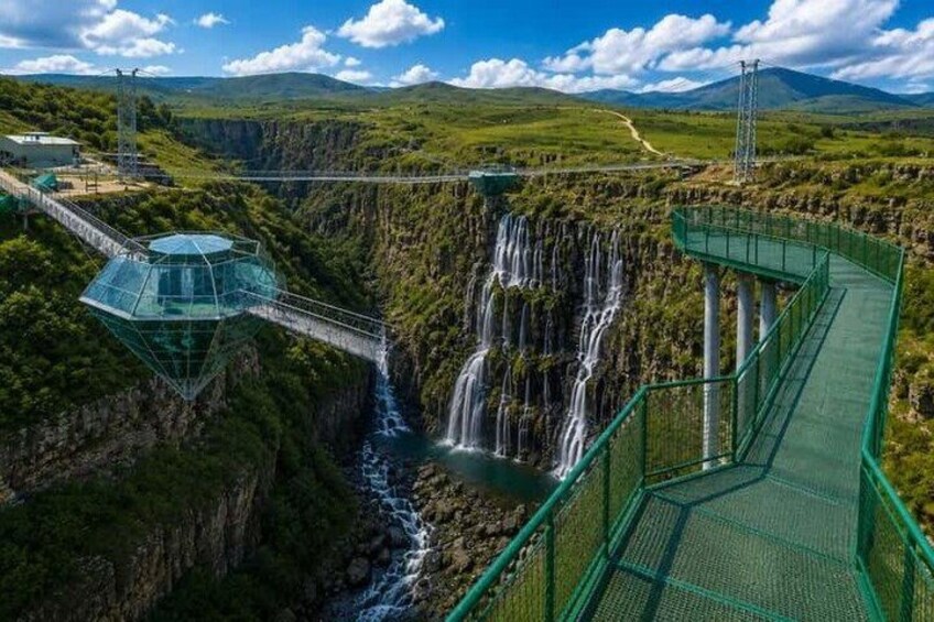 A suspension bridge, a waterfall, and a glasshouse structure. 5