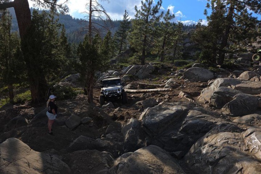 A rocky terrain with a vehicle and a person. 1