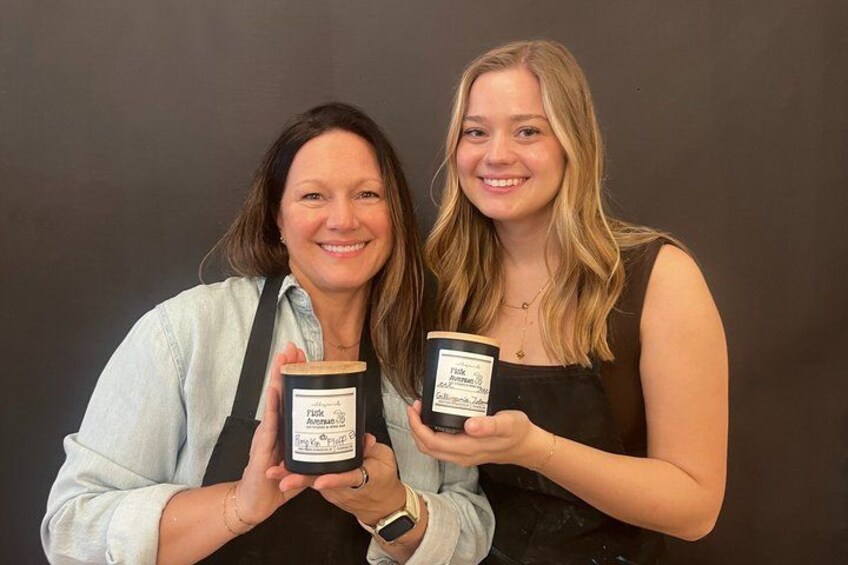Two people holding jars with labels. 1