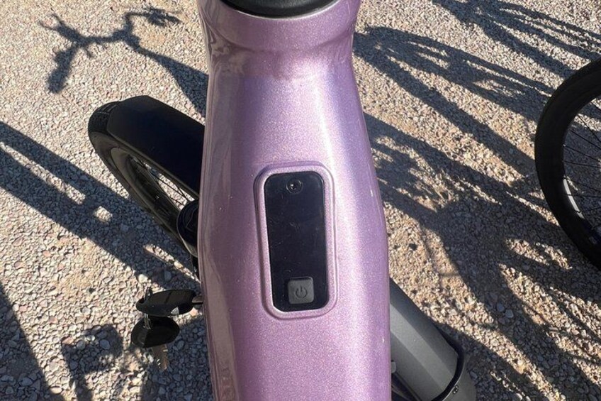 A purple scooter with a black seat and a small rectangular control panel on the front. 5