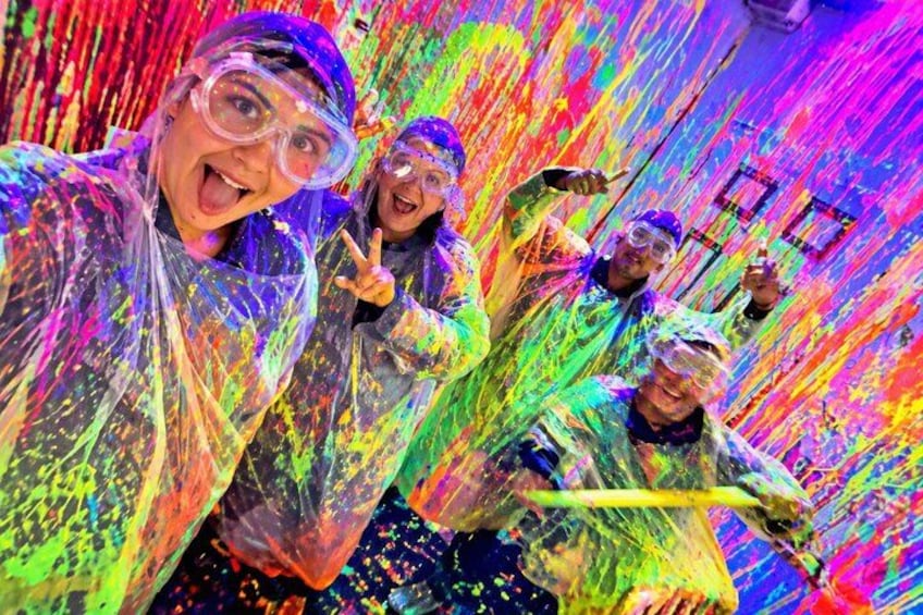 People covered in colorful paint splashes. 1