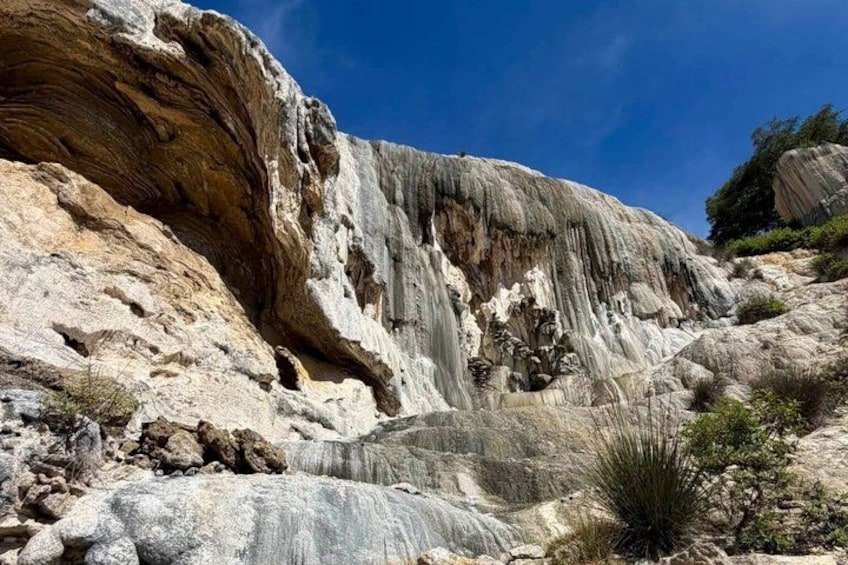 A large rock formation with a waterfall. 2