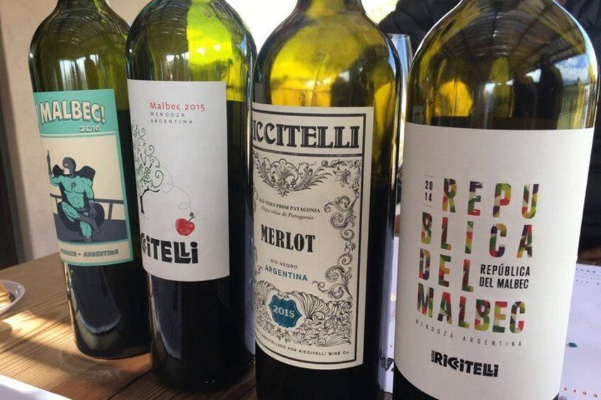 Four wine bottles with labels. 2